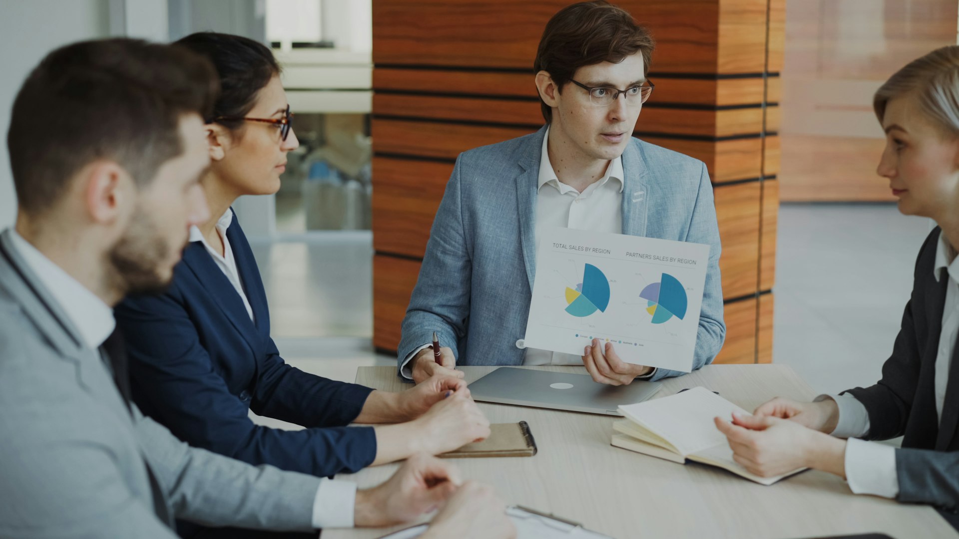 Team discussing charts during a business meeting